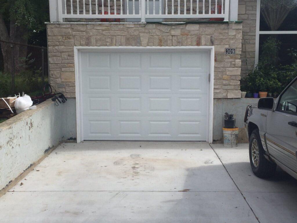 White short panel traditional garage door.
