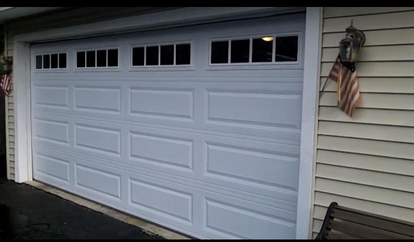 White traditional garage door with windows 