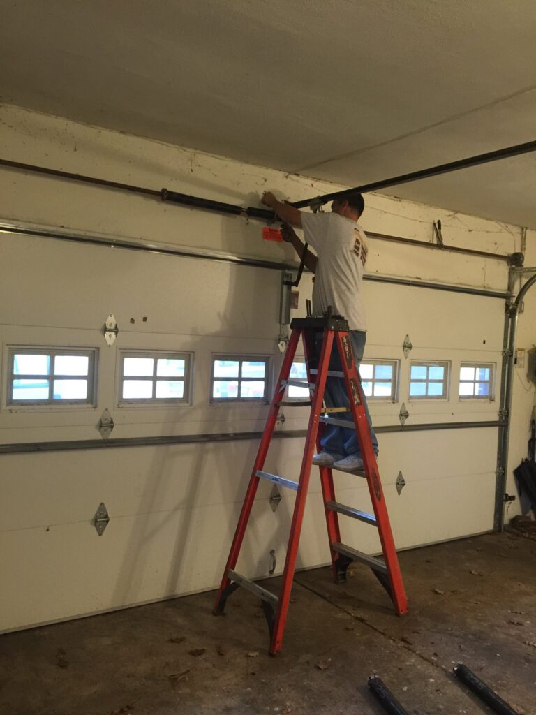 Garage Doors and More technician completing garage door repair